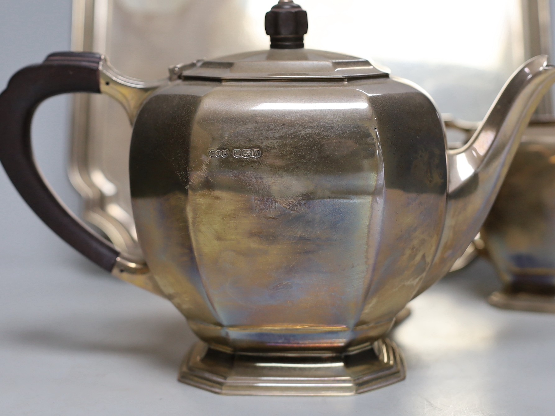 A George VI silver three piece tea set and matching tea tray, E.J.E, Sheffield, 1939, tray with engraved inscription, 30.2cm, gross weight 69.3oz.